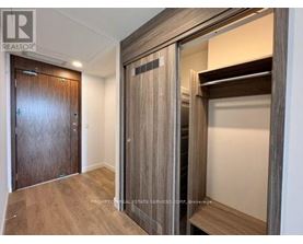 A wooden door with a glass panel is in a room with a wooden floor.