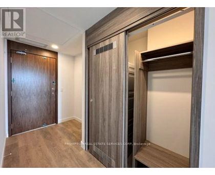 A wooden door with a glass panel is in a room with a wooden floor.