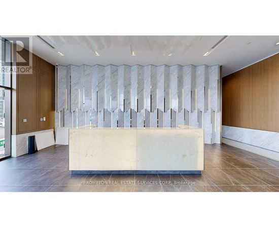 A reception area with a marble counter and a large window.