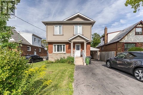 A two-story house with a front yard and a driveway.