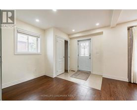 A room with a door and a window with a white frame.