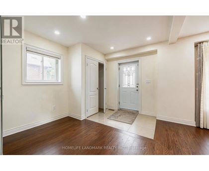A room with a door and a window with a white frame.