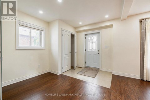 A room with a door and a window with a white frame.