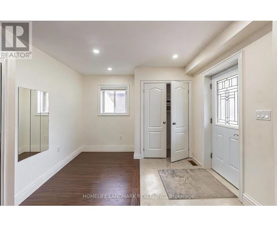A hallway with a wooden floor and white walls.