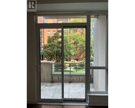 A view of a balcony through a glass door.