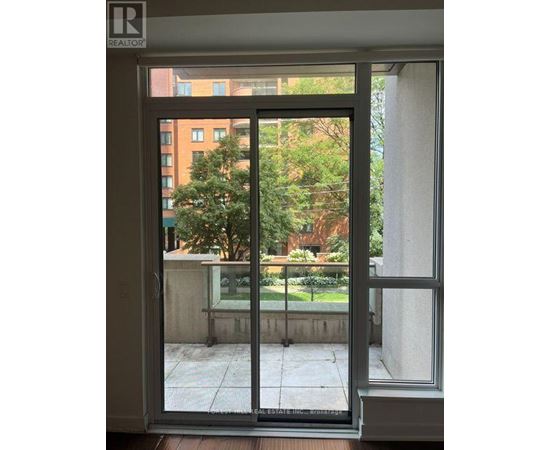 A view of a balcony through a glass door.