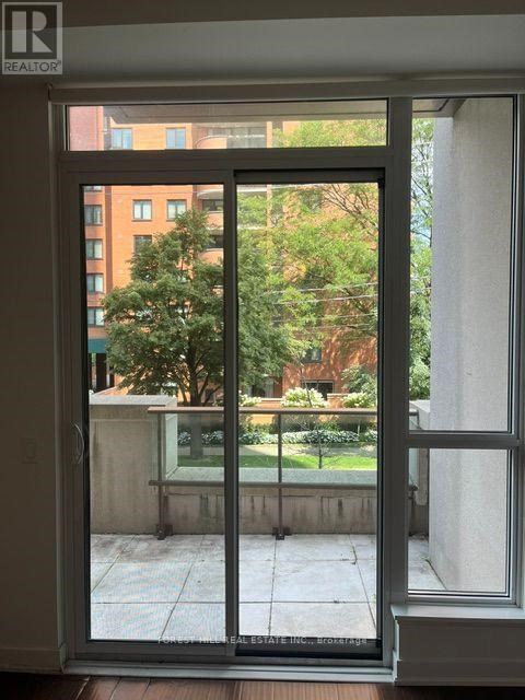 A view of a balcony through a glass door.
