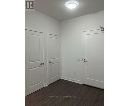 A white door with a silver handle is on the right side of the image.