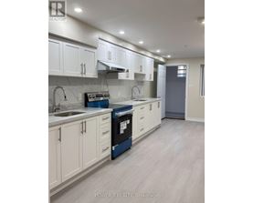 A kitchen with white cabinets and a blue dishwasher.