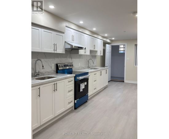 A kitchen with white cabinets and a blue dishwasher.