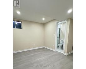 A bathroom with a toilet and a window.