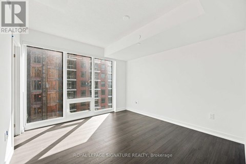 A white room with a sliding door and a view of a building outside.