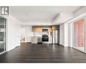 A spacious kitchen with white cabinets and a wooden backsplash.