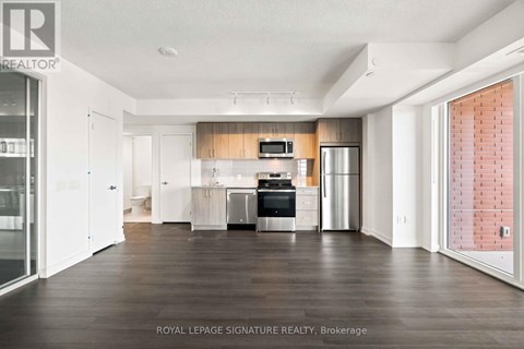 A spacious kitchen with white cabinets and a wooden backsplash.