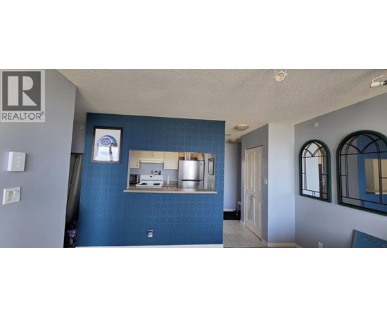 A blue wall with a mirror and a framed picture on it.