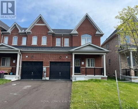 A large brick house with a garage is for sale.