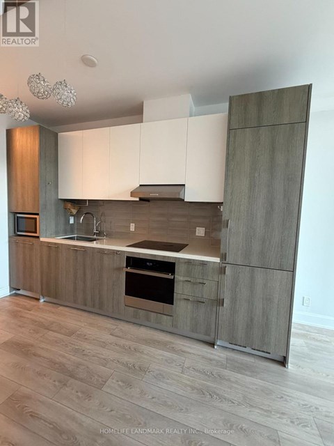 A modern kitchen with wooden cabinets and a stainless steel oven.