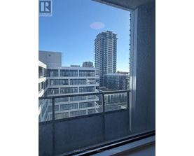 A view from a window of a cityscape with buildings and a clear sky.