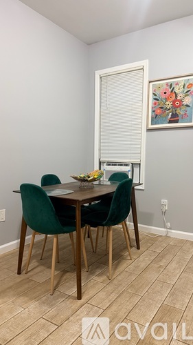 A dining room with a table and chairs.