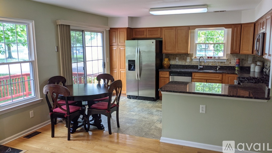 A kitchen with a table and chairs in the middle of the room.