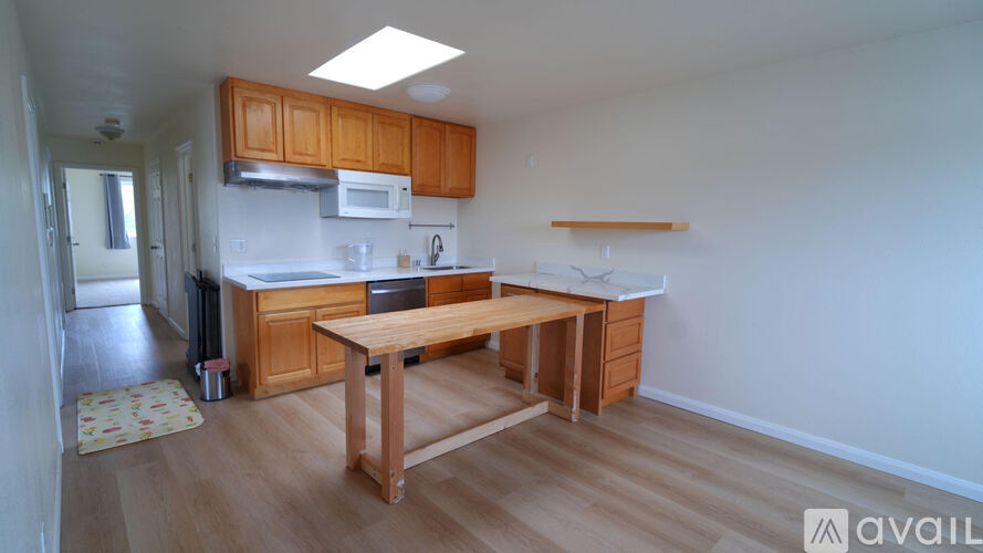 A kitchen with wooden cabinets and a table.