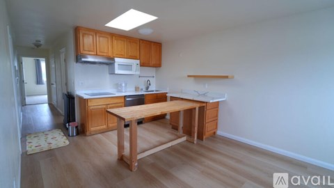 A kitchen with wooden cabinets and a table.