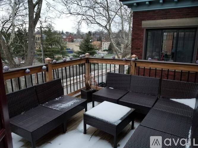 A patio with a table and chairs covered in snow.