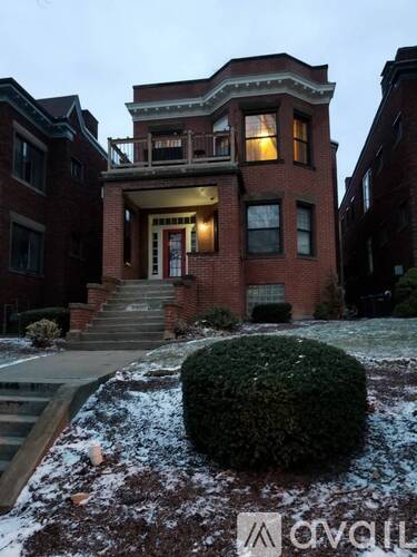 A house with a red brick facade and a white door.