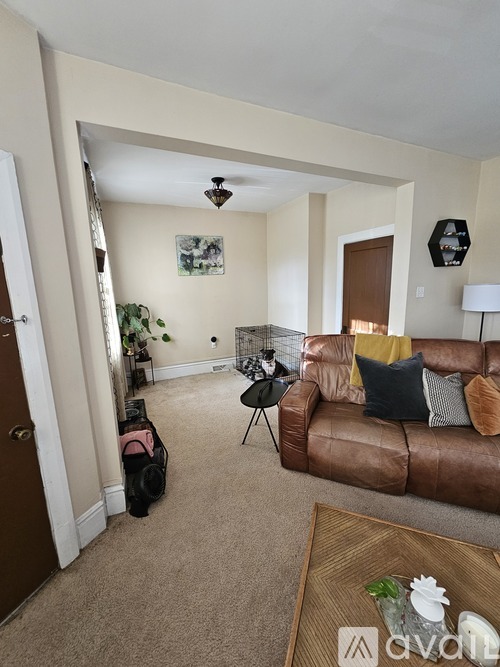 A living room with a brown couch and a coffee table.