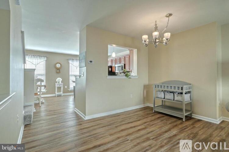 A spacious room with a crib in the corner.