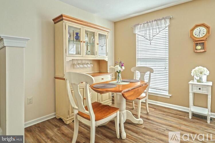 A dining room with a wooden table and chairs.