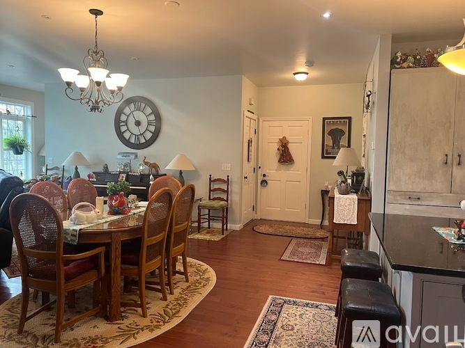 A dining room with a wooden table and chairs.