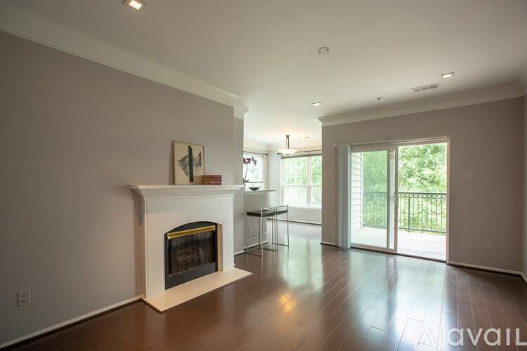 A living room with a fireplace and sliding glass doors.