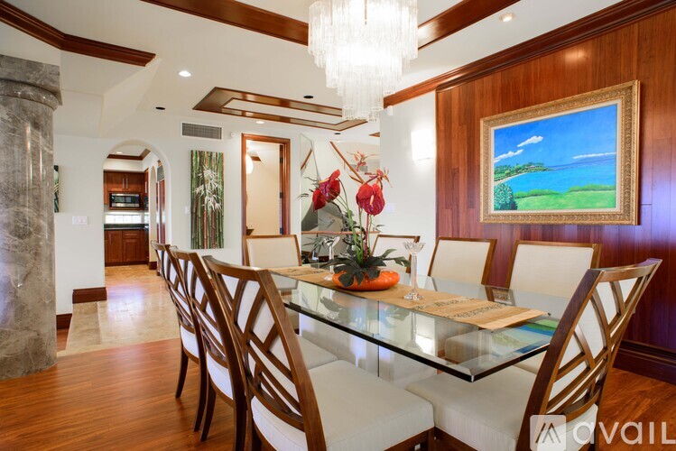 A dining room with a glass table and chairs.