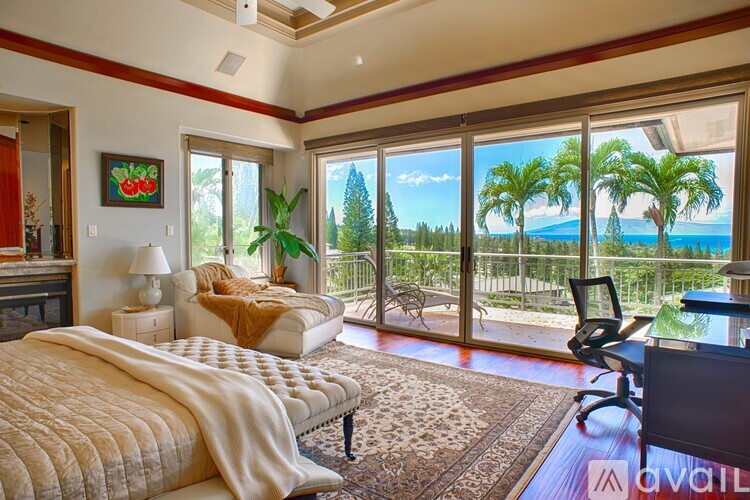 A bedroom with a large bed and a view of the ocean.