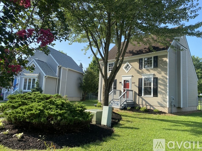 A house with a tree in front of it.