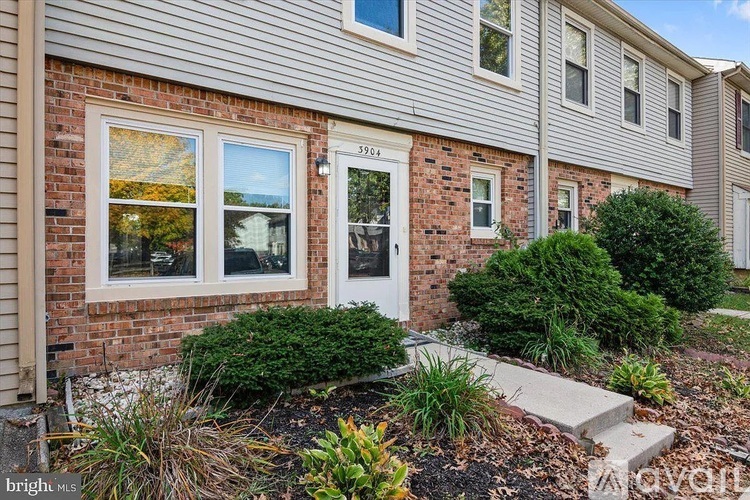 A house with a white door and windows is for sale.