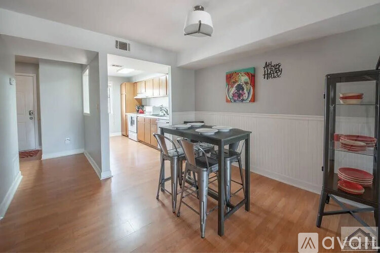 A kitchen area with a dining table and chairs.