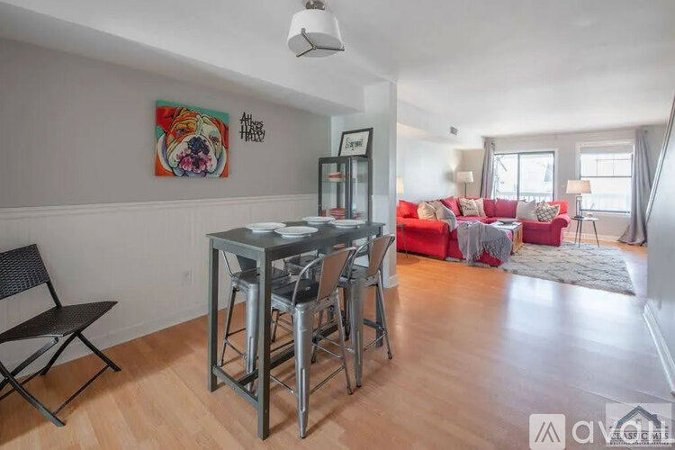 A dining area with a glass table and chairs.