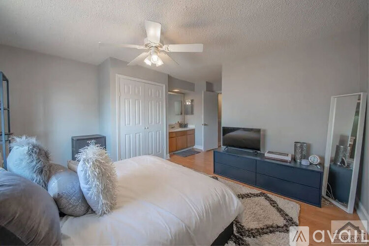 A bedroom with a bed, dresser, and mirror.