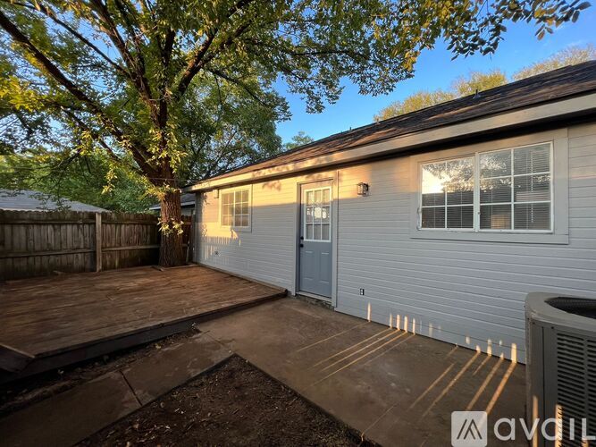 A house with a grey exterior and a wooden deck.