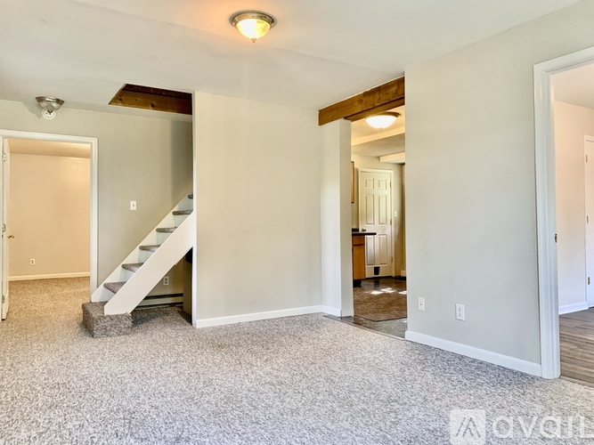 A living room with a staircase leading to the upper floor.