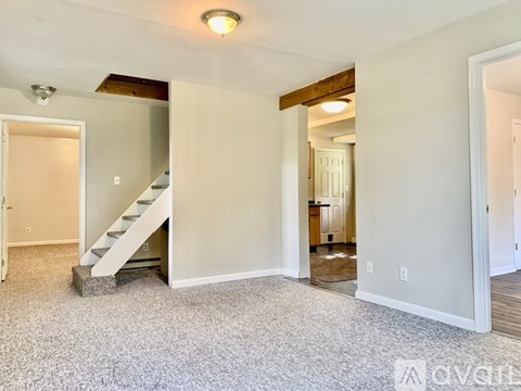 A living room with a staircase leading to the upper floor.