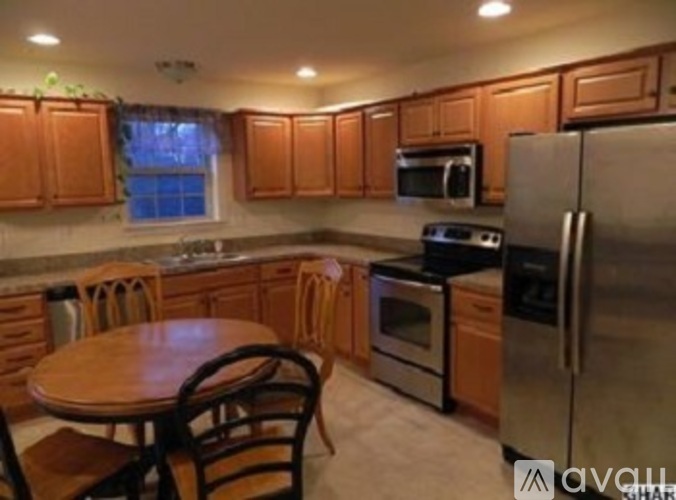 A kitchen with wooden cabinets and stainless steel appliances.