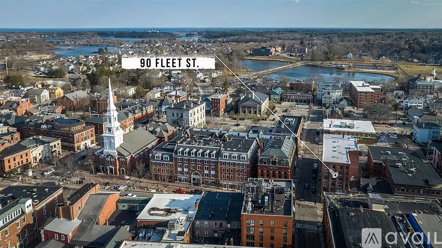 A cityscape with buildings and a church steeple is visible from a high vantage point.
