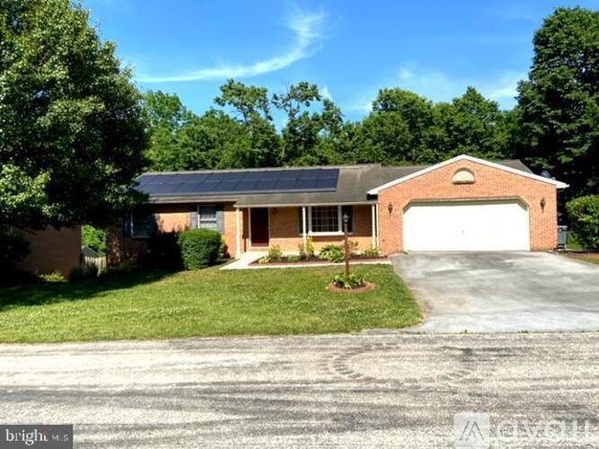 A house with a garage and solar panels on the roof.