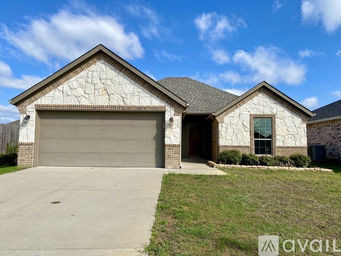 A house with a garage and a driveway in front.