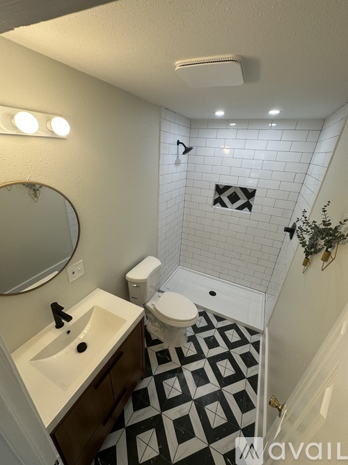 A bathroom with a sink, toilet and tiled floor.
