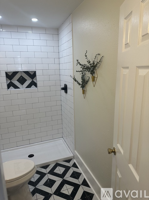 A bathroom with a toilet, a sink, and a door.