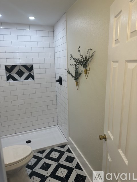 A bathroom with a toilet, a sink, and a door.